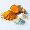 Turmeric root and powder beside pale micronutrient powders