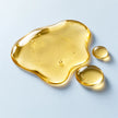 Golden oil droplets in an illustrative vitamin E composition