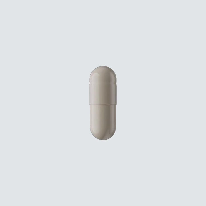 Hair Activation Complex capsule opening with fine golden powder on a pale blue background